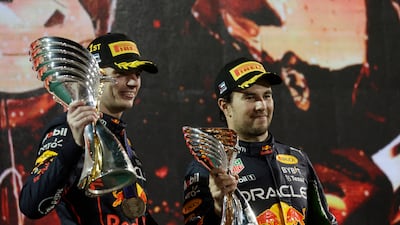 Red Bull's Max Verstappen celebrates on the podium after winning the Abu Dhabi Grand Prix alongside third-placed teammate Sergio Perez at Yas Marina Circuit on Sunday, November 20, 2022. Reuters
