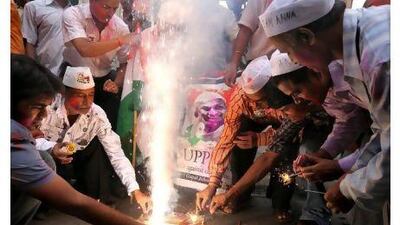 Supporters of anti-corruption activist Anna Hazare light fireworks in Kolkata Sunday.