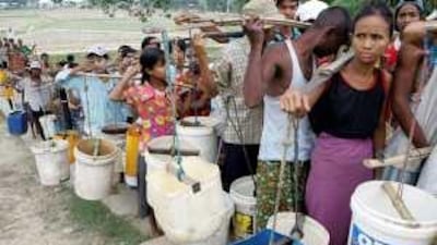 People queue for drinking water in Yangon, where many struggle with the psychological effects of last year's Cyclone Nargis, which killed nearly 140,000 people and left two million homeless.