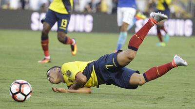 Ecuador’s Jefferson Montero falls to the ground after he was fouled by Brazil’s Elias. Jae C. Hong / AP Photo