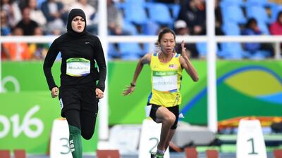 Saudi Arabia's Kariman Abuljadayel and Malaysia's Zaidatul Husniah Zulkifli compete in the women's 100m preliminary round at Rio. Jewel Samad / AFP