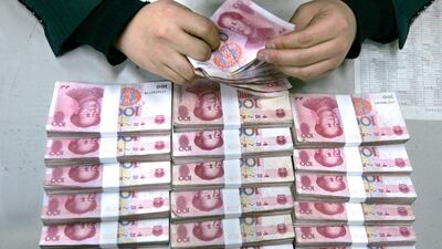 An employee counts yuan banknotes at a branch of the Bank of China in Taiyuan, Shanxi province. Reuters