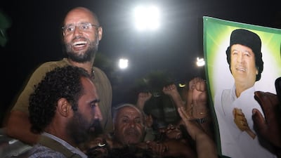Saif Al Islam Qaddafi, standing, was a prominent figure under his father Muammar's regime in Libya. AFP