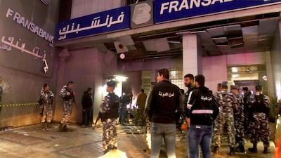 Lebanese security forces inspect the Fransabank branch in Saida after it was attacked with an explosive device. AFPinspect