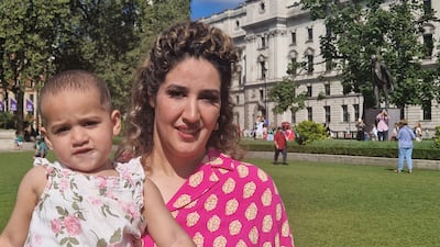 Sadaf Farzan poses with her daughter in London at a protest against the Taliban. Victoria Pertusa / The National