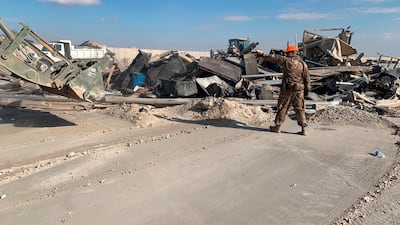 US soldiers clear rubble from a site of Iranian bombing at Ain Al Asad air base in Anbar. AP