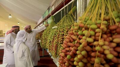 Visitors take a close look at the produce on display on Saturday, the opening day of this year’s Liwa Date Festival. More than three tonnes of dates were entered in the opening round of the competitions. Ravindranath K / The National