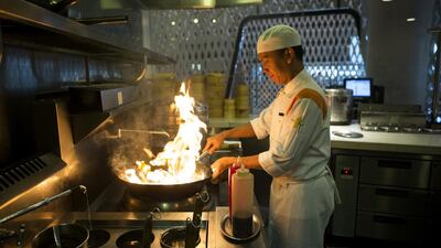 A chef prepares the kitchen of the Noodle Box restaurant before dinner at the Yas Viceroy Hotel in Abu Dhabi. Christopher Pike / The National