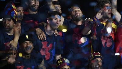 Barcelona’s Argentinian forward Lionel Messi (2ndL) and teammates gesture as they take part in the celebrations held for their victory over Juventus, one day after the UEFA Champions League final football, at the Camp Nou stadium in Barcelona on June 7, 2015. Luis Suarez and Neymar scored second-half goals to give Barcelona a 3-1 Champions League final victory over Juventus on June 6, 2015 as the Spaniards became the first team to twice win the European treble. AFP PHOTO/ JOSEP LAGO