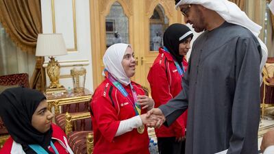 Sheikh Mohammed bin Zayed greets a member of the UAE Disabled Sports Federation during a Sea Palace barza in January. Rashed Al Mansoori / Crown Prince Court — Abu Dhabi