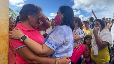 Vice President Leni Robredo, foreground right, comforts a woman after inspecting damage caused by Typhoon Rai on the Dinagat Islands, the Philippines. AP