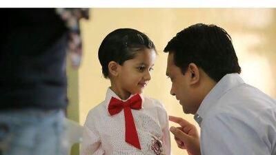 Tvisha, a kindergarten pupil, listens to her father Rikesh at The Elite English School in Dubai.