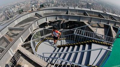 France’s Clement Dumont reaches the top of the World Trade Center Tower in Beijing on Saturday. Diego Azubel / EPA