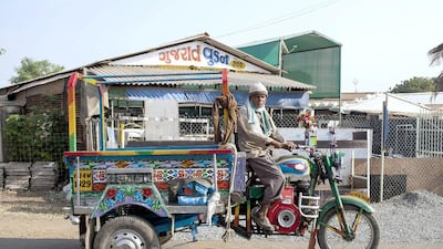 These three-wheeled lorries used to ferry workers but now find fewer customers as the numbers of workers employed in yards has gone down. Subhash Sharma for The National