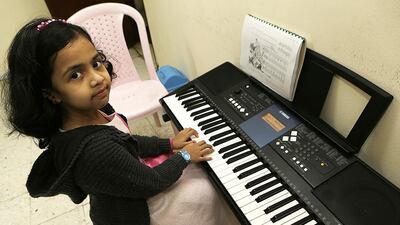 Zoeya Mehwish, 7, practises the keyboard during her free time at Roses Music and Learning Centre in Fujairah, on December 14, 2016. Jeffrey E Biteng / The National