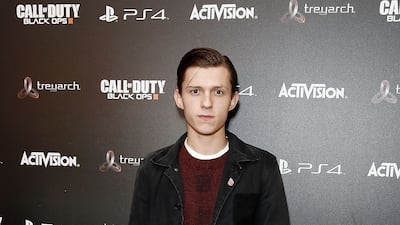 Tom Holland, in a red jumper and black jacket, attends the 'Call of Duty Black Ops III' launch on November 5, 2015 in London. Getty Images
