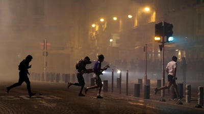 People run after police use tear gas to disperse soccer fans during clashes following the UEFA EURO 2016 group B soccer match between England and Russia in the port of Marseille, France. Tolga Bozoglu / EPA