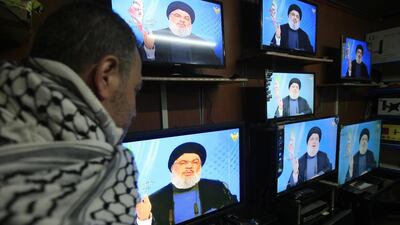 A man watches Hizbollah leader Hassan Nasrallah’s televised speech on December 21, 2015, through the window of an electronics shop in Lebanon’s southern port city of Sidon. Mohammed Zaatari / AP Photo