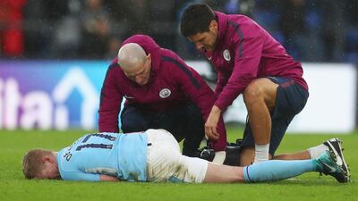 An injured Kevin de Bruyne of Manchester City is given assistance by City's medical staff during the Premier League match against Crystal Palace at Selhurst Park. The match ended 0-0, ending City's run of 18 straight league wins. Catherine Ivill / Getty Images