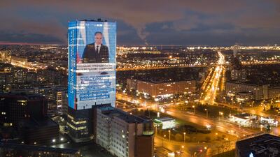 An electronic screen, installed on the facade of a business tower in St Petersburg, shows Russian President Vladimir Putin during his annual state of the nation address. AP