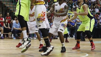 Jarrid Famous of GlobalPort Batang Pier goes up for a shot against Raymond Almazan of Rain or Shine Elasto Painters in their PBA game in Dubai on Thursday. Antonie Robertson / The National