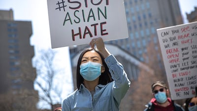 A woman holds a placard during a Stop Asian Hate rally in New York in April 2021. Reuters