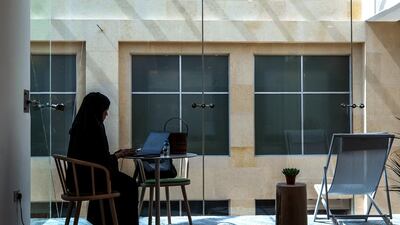A woman works on her laptop at Cloud Spaces.