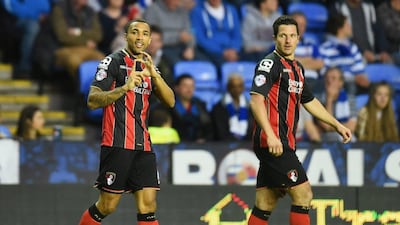 Callum Wilson of Bournemouth, left, celebrates after scoring their goal in a 1-0 Championship win against Reading on Tuesday. Tom Dulat / Getty Images / April 14, 2015