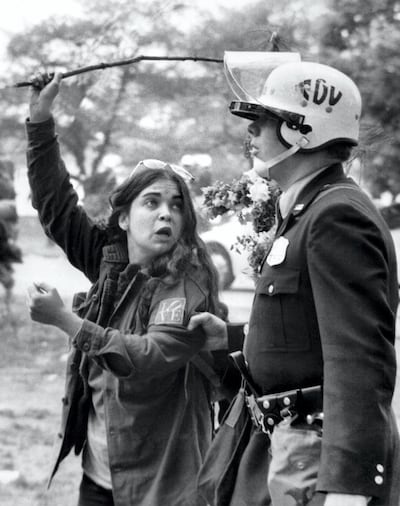 In May 1971, a demonstrator in Washington teases a policeman with a flower during the largest non-violent direct action in US history to protest against the Vietnam War. AFP