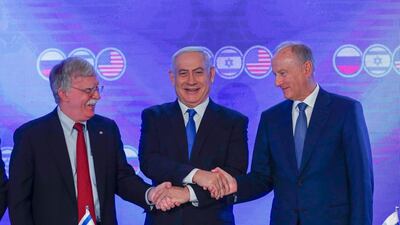 Nikolai Patrushev, right, Russian Secretary of the Security Council, Israeli Prime Minister Benjamin Netanyahu, centre, and US National Security Advisor John Bolton, left, link hands during a press conference of the trilateral meeting in Jerusalem, Israel. EPA