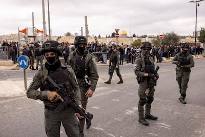 Israeli security officers stand guard as Palestinians hold Friday prayers in Jerusalem. Getty Images