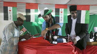 Afghan Ibrahim Saeed and his cricket-loving friends in Mussaffah have called stumps on their games for the next month to concentrate on a bigger love – that for the UAE. The 25 expats are working on a 5km-long flag for National Day. Mona Al Marzooqi / The National