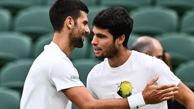 Novak Djokovic, left, shakes hands with Carlos Alcaraz during a practise session prior to their men's singles semi-finals matches at Wimbledon. AFP