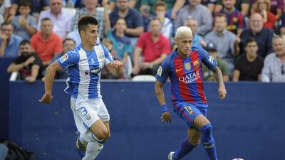 Barcelona’s Neymar, right, vies with Leganes defender Unai Bustinza. Pedro Armestre / AFP