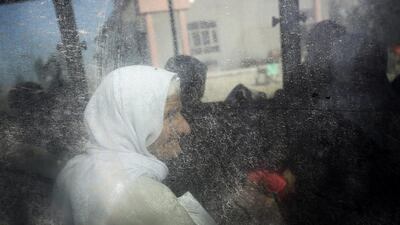 An elderly Yazidi woman who was released by Islamic militants waits inside a bus before being driven to the Kurdish city of Dohuk, in Alton Kupri, outside Kirkuk, Iraq. The Islamic State group released about 200 Yazidis held for five months in Iraq, mostly elderly, infirm captives who likely slowed the extremists down, Kurdish military officials said Sunday. Bram Janssen / AP