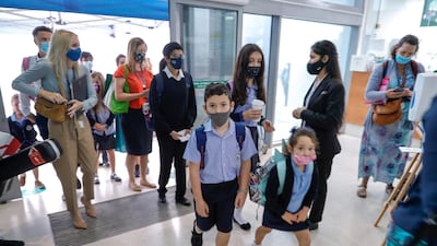 Pupils make their way through the school doors.