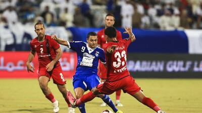 Al Nasr's Eder Luis de Oliveira tries for the ball against Al Shaab's Ahmad Eissa Ahmad Kamel during their Arabian Gulf League second round match at Al Maktoum Stadium in Dubai. Nasr prevailed 2-1 on goals from Ibrahima Toure and Habib Fardan. Sarah Dea / The National