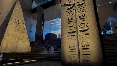 A picture shows on October 15, 2024, ancient Egyptian colossal statues along the Grand Staircase at the Grand Egyptian Museum in Giza during the trial Operation of the Grand Egyptian Museum. (Photo by Khaled DESOUKI / AFP)