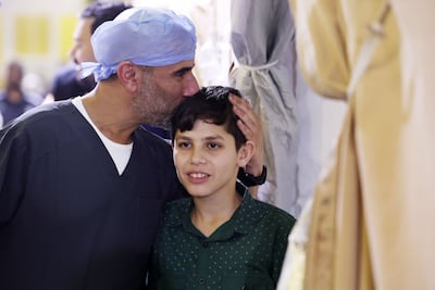 Dr Hamed Al Ahmad with a young patient on the floating hospital. Chris Whiteoak / The National