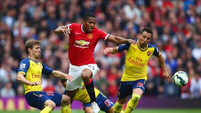 Antonio Valencia takes on Nacho Monreal, Alexis Sanchez and Santi Cazorla. Clive Rose / Getty Images