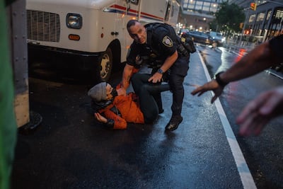 A police officer tackles a protester on the street during an immigration protest in Manhattan, New York. EPA