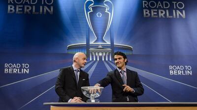 Uefa secretary general Gianni Infantino, left, and the ambassador for the final in Berlin, Karl-Heinz Riedle, hold the draw for the quarter-final matches at Uefa headquarters in Nyon on March 20, 2015. Fabrice Coffrini / AFP
