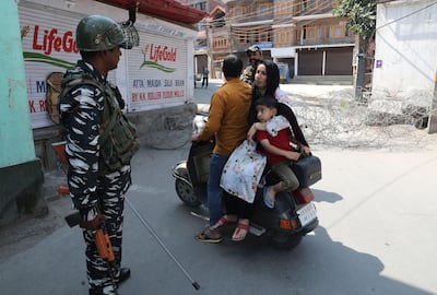 Indian paramilitary soldiers stop people at a roadblock in Srinagar, Kashmir, after the death of separatist leader Syed Ali Geelani. EPA