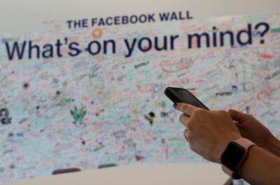 A woman uses her mobile at the Facebook office in Dubai, UAE. AP
