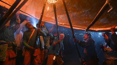 People prepare to release a hot-air balloon loaded with fireworks during the light festival in Taunggyi, Myanmar. AFP