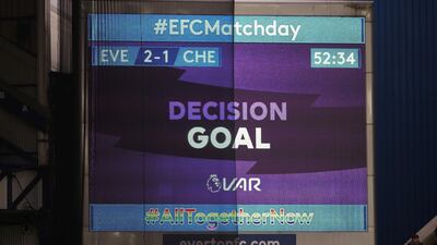 The big screen displays a VAR review message after Chelsea's first goal. Reuters
