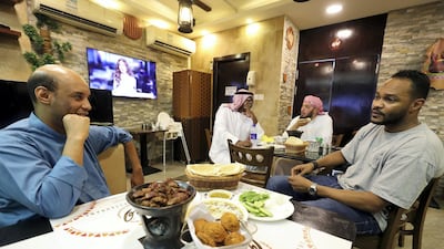 Co-owner Mujahid Salah, right, talks about the restaurant.