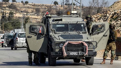Israeli soldiers stand guard in the village of Halhul, north of the city of Hebron, in the occupied West Bank. AFP