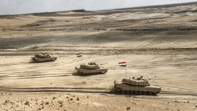 Egyptian tanks drive in formation through the Matrouh Governorate desert. AFP