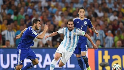 Gonzalo Higuain, centre, of Argentina controls the ball against Muhamed Besic of Bosnia and Herzegovina, right, during the 2014 FIFA World Cup Brazil Group F match at Maracana on June 15, 2014 in Rio de Janeiro, Brazil. Matthias Hangst/Getty Images